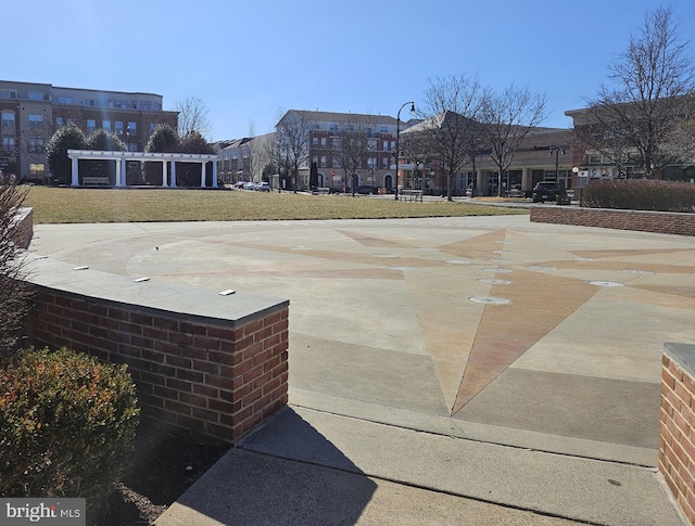 view of basketball court featuring a yard and a pergola