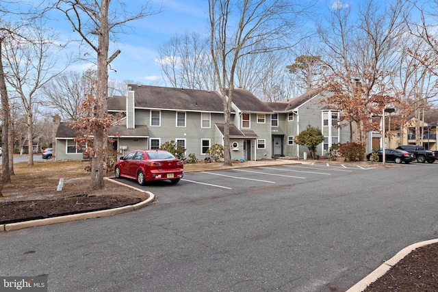 view of property with uncovered parking and a residential view