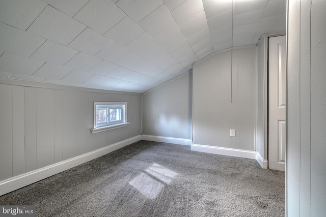 additional living space featuring lofted ceiling, carpet floors, and baseboards