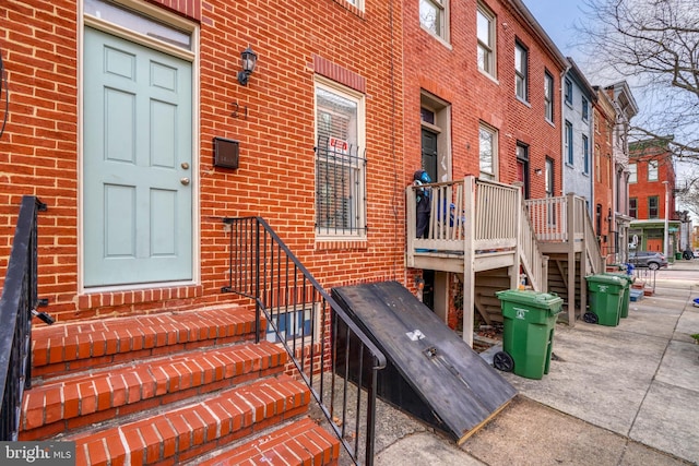 view of exterior entry with brick siding