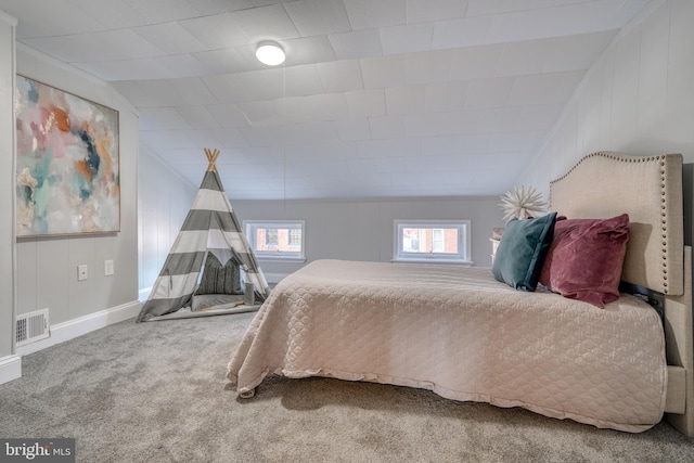 carpeted bedroom featuring lofted ceiling, visible vents, and baseboards