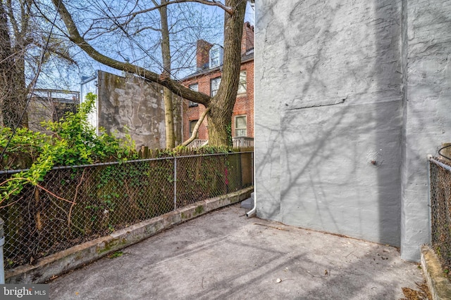 view of gate featuring a patio and fence