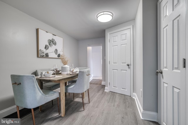 dining room with light wood-style floors and baseboards