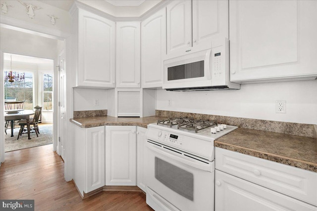 kitchen featuring light wood-style floors, white appliances, and white cabinetry