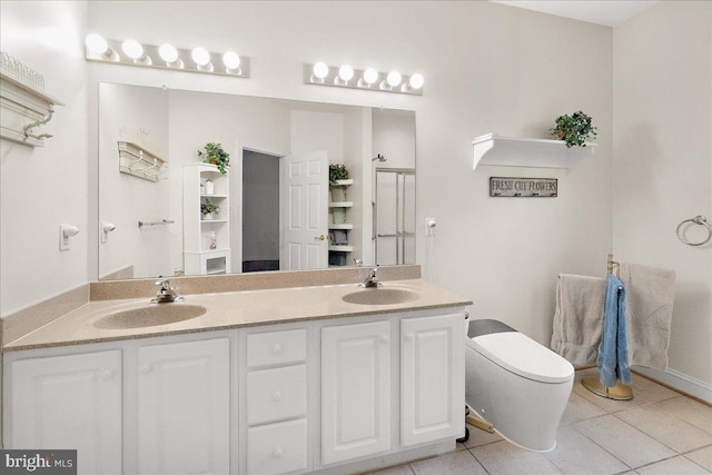 bathroom with toilet, tile patterned flooring, double vanity, and a sink