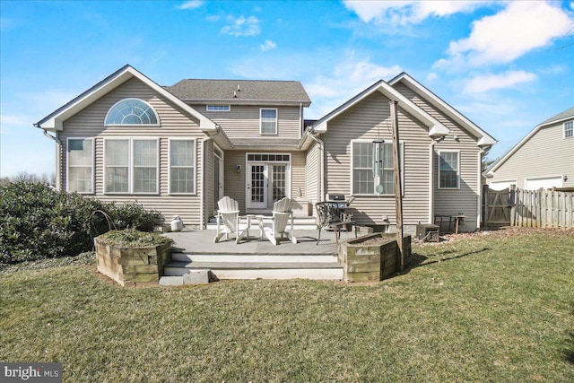 back of house featuring a yard and fence