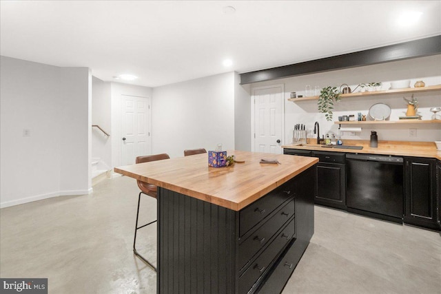 kitchen with butcher block countertops, a breakfast bar, dark cabinetry, and dishwasher