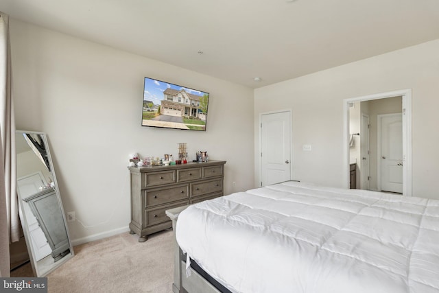 bedroom with baseboards and light colored carpet
