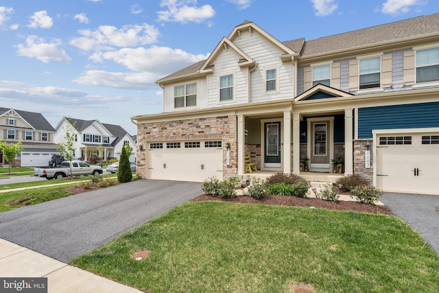 craftsman house with stone siding, covered porch, driveway, and an attached garage