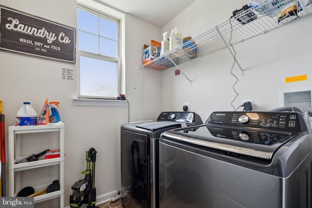 laundry area with plenty of natural light, separate washer and dryer, laundry area, and baseboards