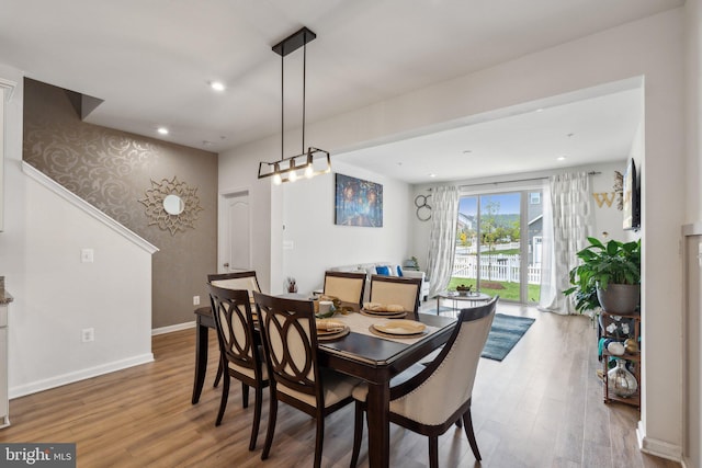 dining space with baseboards, recessed lighting, and wood finished floors