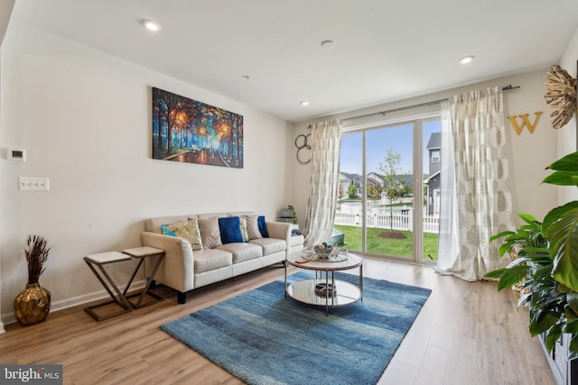 living area featuring wood finished floors and recessed lighting