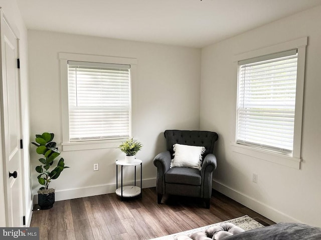 sitting room featuring baseboards and dark wood finished floors