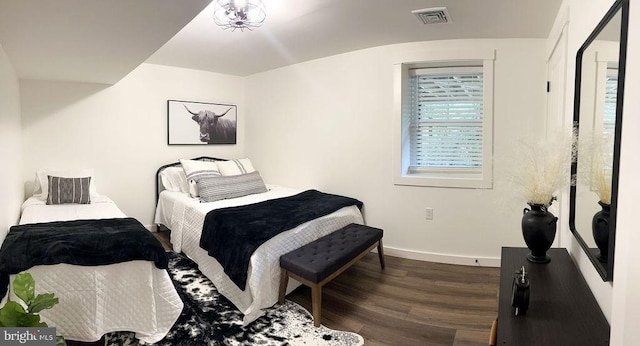 bedroom featuring dark wood-style floors, baseboards, and visible vents