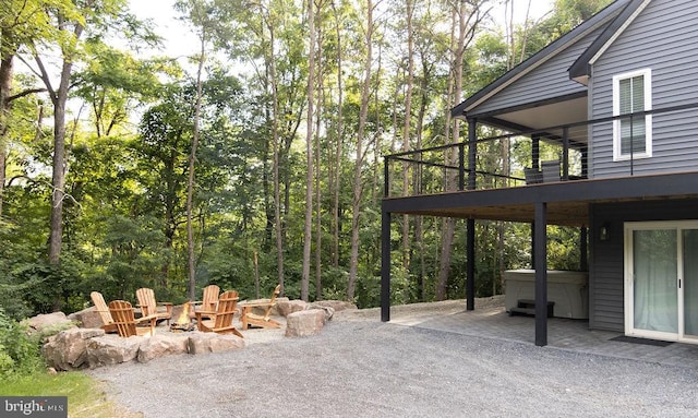 view of patio featuring a fire pit and a hot tub