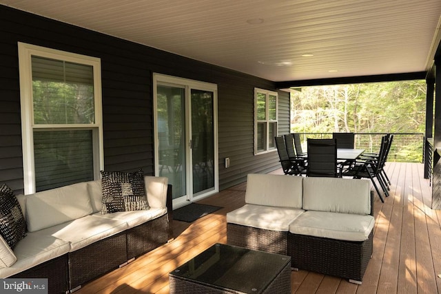 wooden deck with outdoor dining area and an outdoor living space