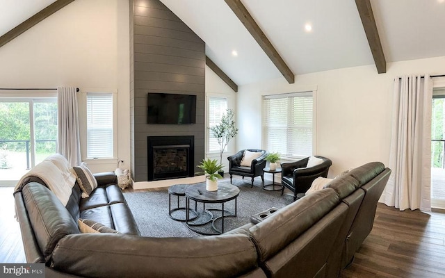 living area featuring dark wood-style floors, recessed lighting, a large fireplace, high vaulted ceiling, and beamed ceiling