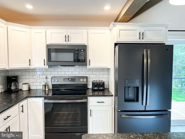 kitchen featuring black range with electric stovetop, white cabinets, dark stone counters, tasteful backsplash, and stainless steel fridge