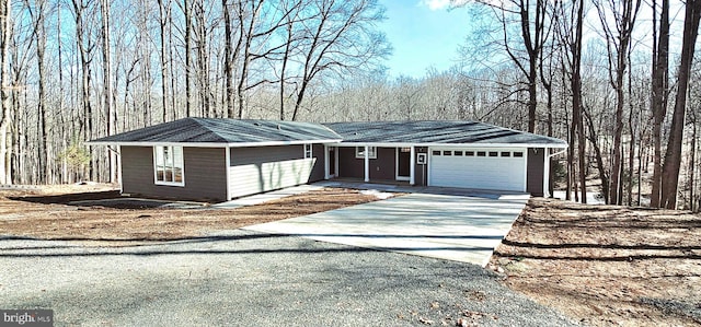 ranch-style house featuring a garage and concrete driveway