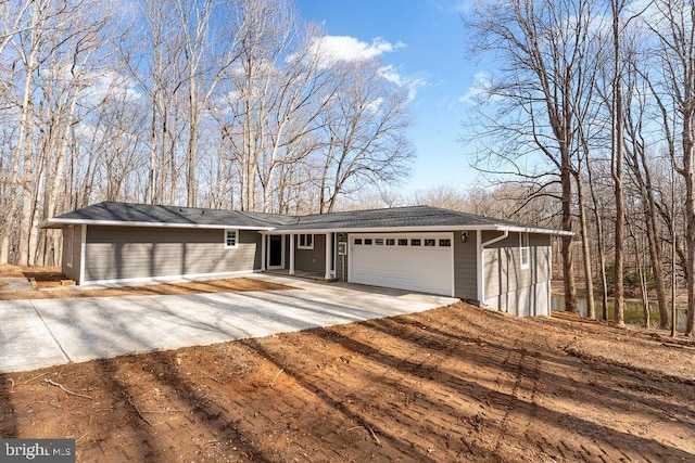 ranch-style house with an attached garage and concrete driveway