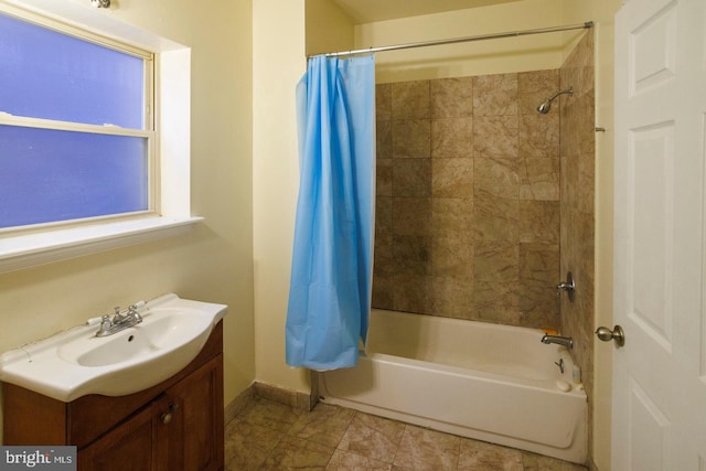 full bath with baseboards, shower / bath combination with curtain, and vanity