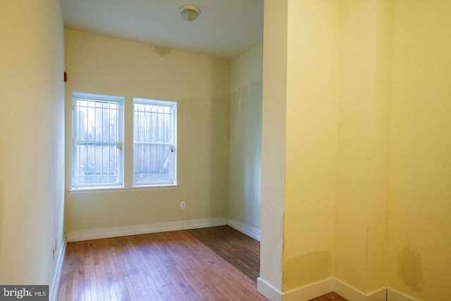 unfurnished room featuring wood finished floors and baseboards