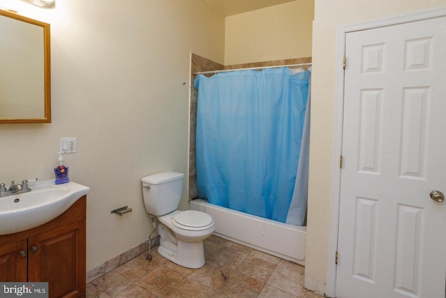 bathroom with toilet, shower / bath combination with curtain, vanity, and baseboards