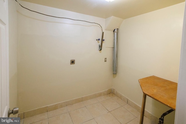 washroom with laundry area, baseboards, tile patterned floors, hookup for a washing machine, and electric dryer hookup