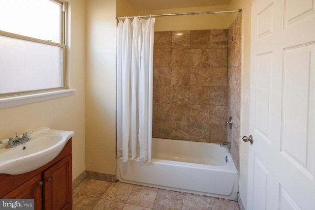 bathroom featuring baseboards, tile patterned floors, vanity, and shower / bathtub combination with curtain