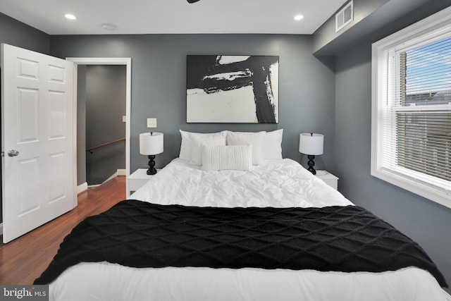 bedroom featuring recessed lighting, dark wood-style flooring, visible vents, and baseboards