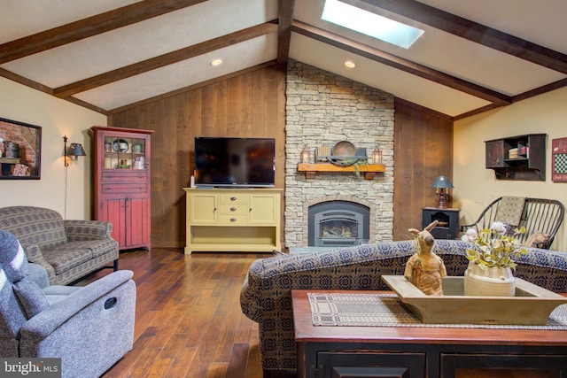 living room with a stone fireplace, lofted ceiling with skylight, wood-type flooring, and wooden walls