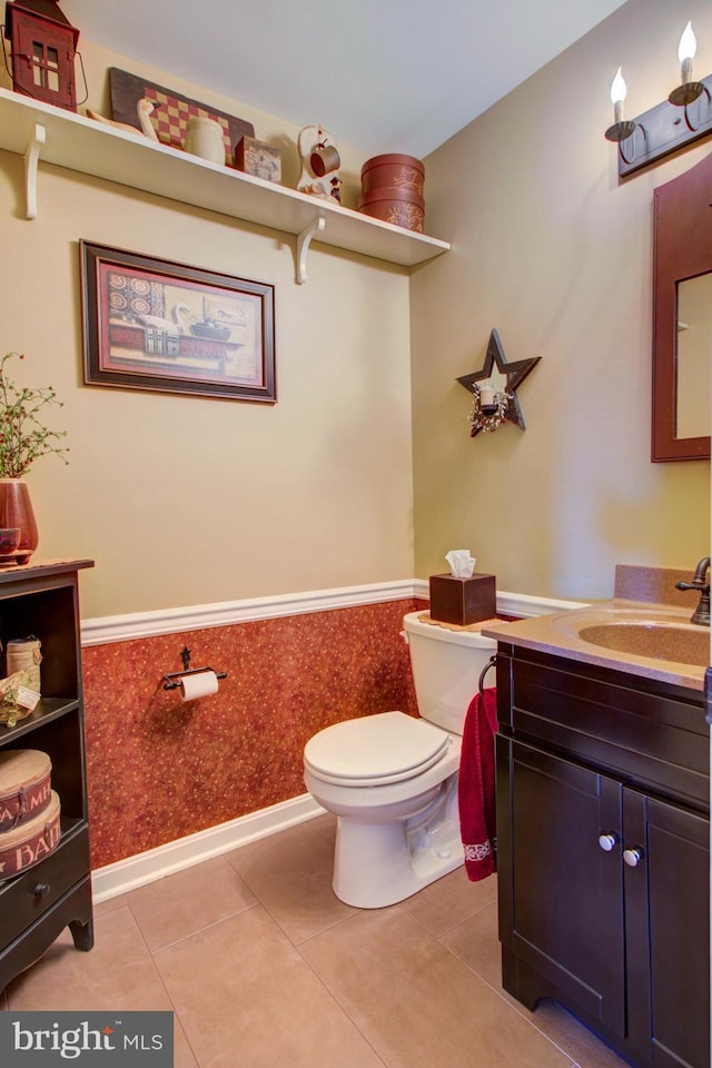 bathroom with wainscoting, vanity, toilet, and tile patterned floors