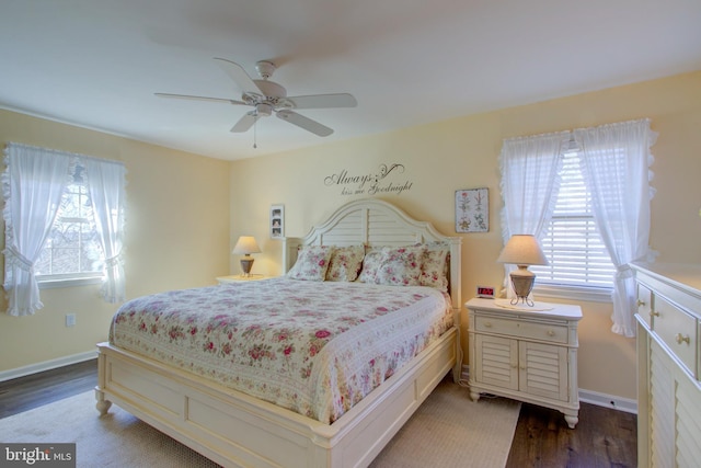 bedroom with a ceiling fan, baseboards, and wood finished floors