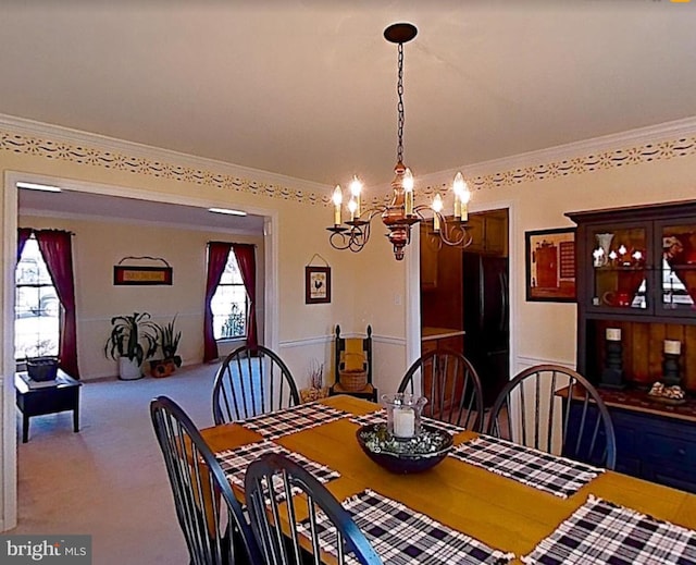 dining room featuring carpet floors and ornamental molding