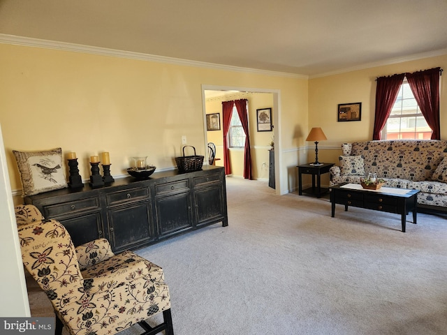 sitting room with light carpet and crown molding