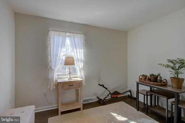 misc room with baseboards, visible vents, and dark wood-style flooring