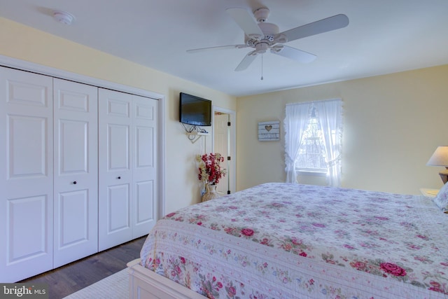 bedroom with dark wood-style floors, a closet, and a ceiling fan