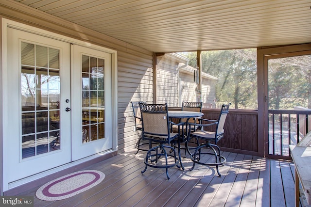 sunroom / solarium featuring a healthy amount of sunlight and french doors