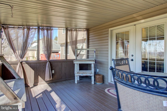 unfurnished sunroom featuring french doors