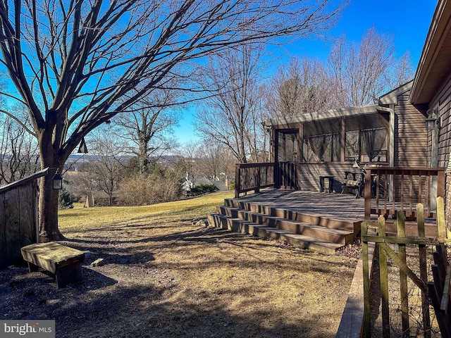 view of yard with a deck and a sunroom