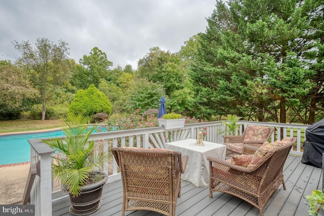 deck with an outdoor hangout area and an outdoor pool