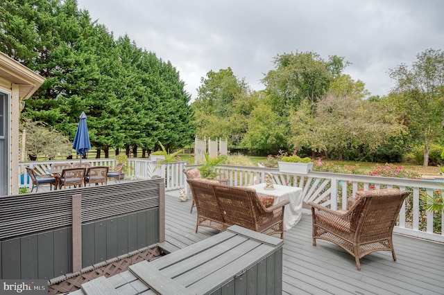 wooden deck with outdoor dining area and an outdoor living space