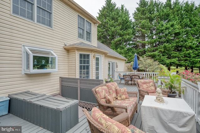 deck with outdoor dining space and outdoor lounge area