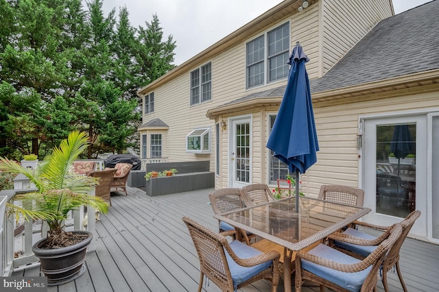 wooden deck with outdoor dining space