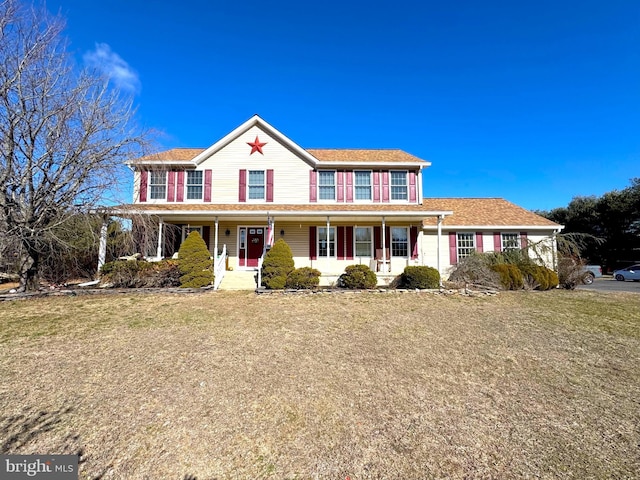 view of front of home featuring covered porch and a front lawn