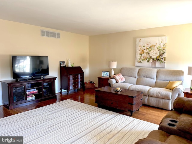 living room featuring wood finished floors and visible vents