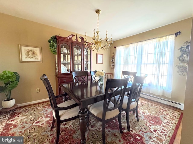 dining space with baseboards, baseboard heating, and a notable chandelier