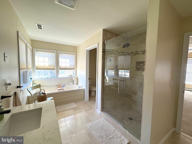 bathroom featuring a stall shower, baseboards, visible vents, toilet, and vanity