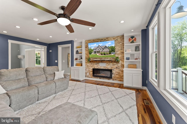 36976 Walnut Park Ln, Purcellville, VA 20132 - living room featuring wood finished floors, recessed lighting, a stone fireplace, built in features, and a ceiling fan