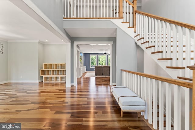 36976 Walnut Park Ln, Purcellville, VA 20132 - staircase featuring wood finished floors, baseboards, a towering ceiling, and crown molding